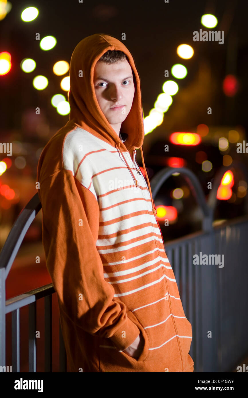 Displeased young punk slanging on the corner at night Stock Photo Alamy