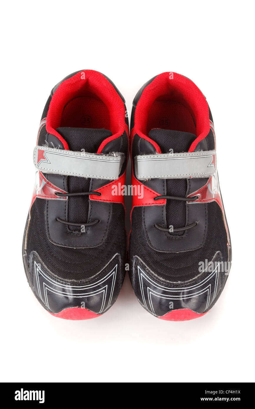 Pair of sports shoes, black and red colors on white background. Isolated. View from above Stock