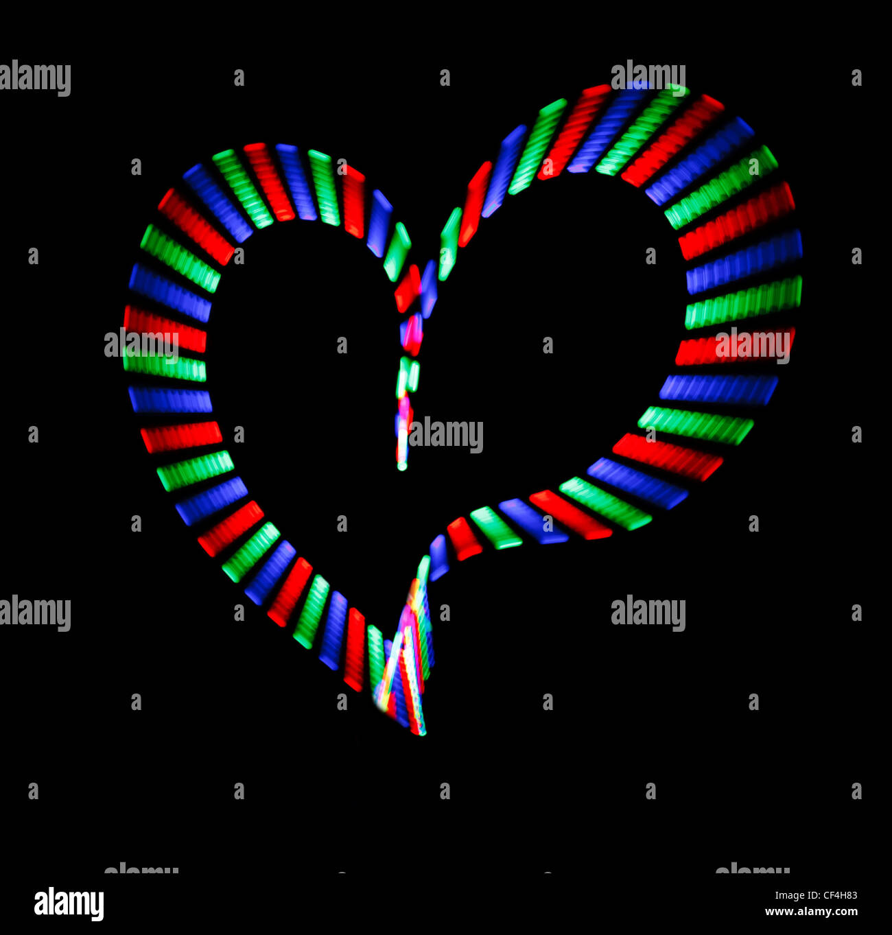 Multicoloured shone heart on black background. Love symbol Stock Photo