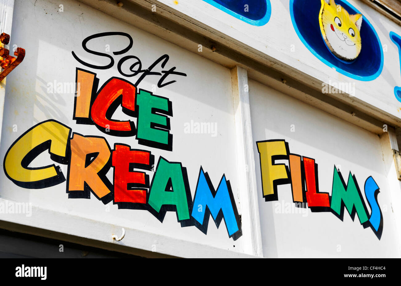 Soft Ice Cream and Films written in colourful lettering on a sign above a shop on the seafront at Paignton on the English Rivier Stock Photo