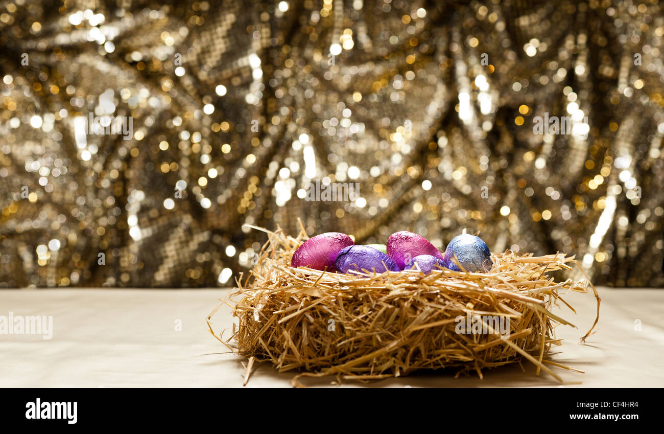Chocolate Easter eggs in a natural straw nest in front of a beautiful ...