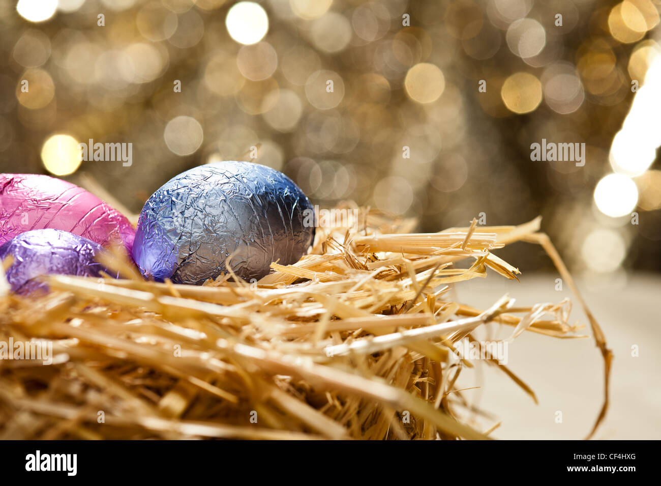 Chocolate Easter eggs in a natural straw nest in front of a beautiful ...