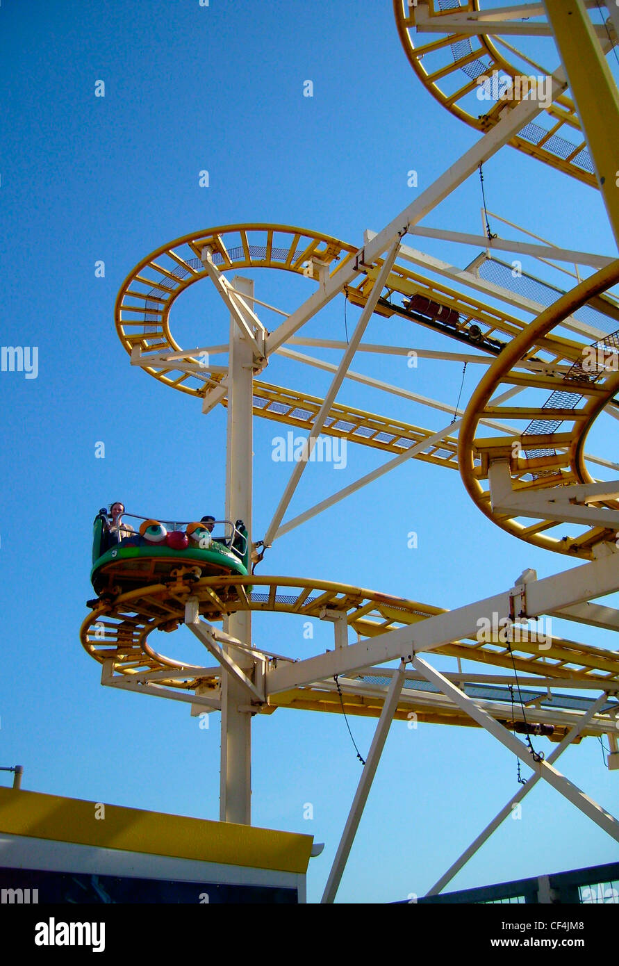 People enjoying a ride on the Crazy Mouse ride on Brighton Pier. Stock Photo