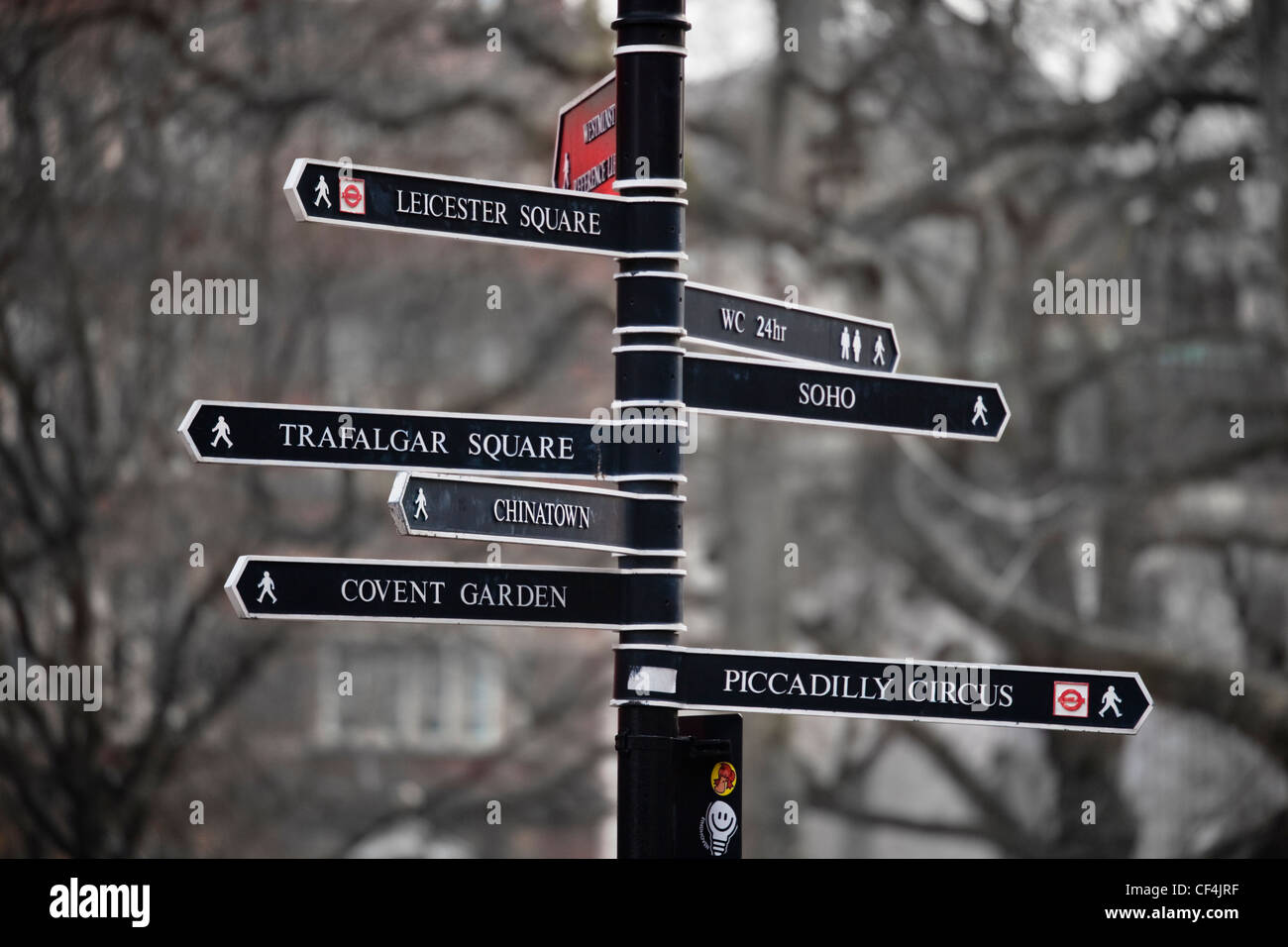 A black and white metal sign post pointing to many famous places in London. Stock Photo