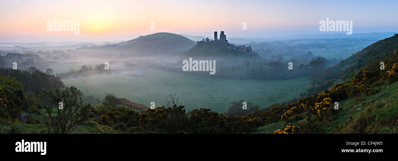 View towards Corfe Castle from West Hill on a misty sunrise. Stock Photo