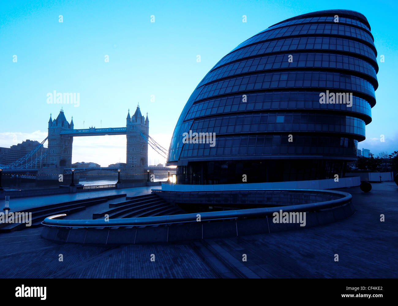 Tower Bridge and City Hall at dawn. City Hall is headquarters of the Greater London Authority, the building was designed by Norm Stock Photo