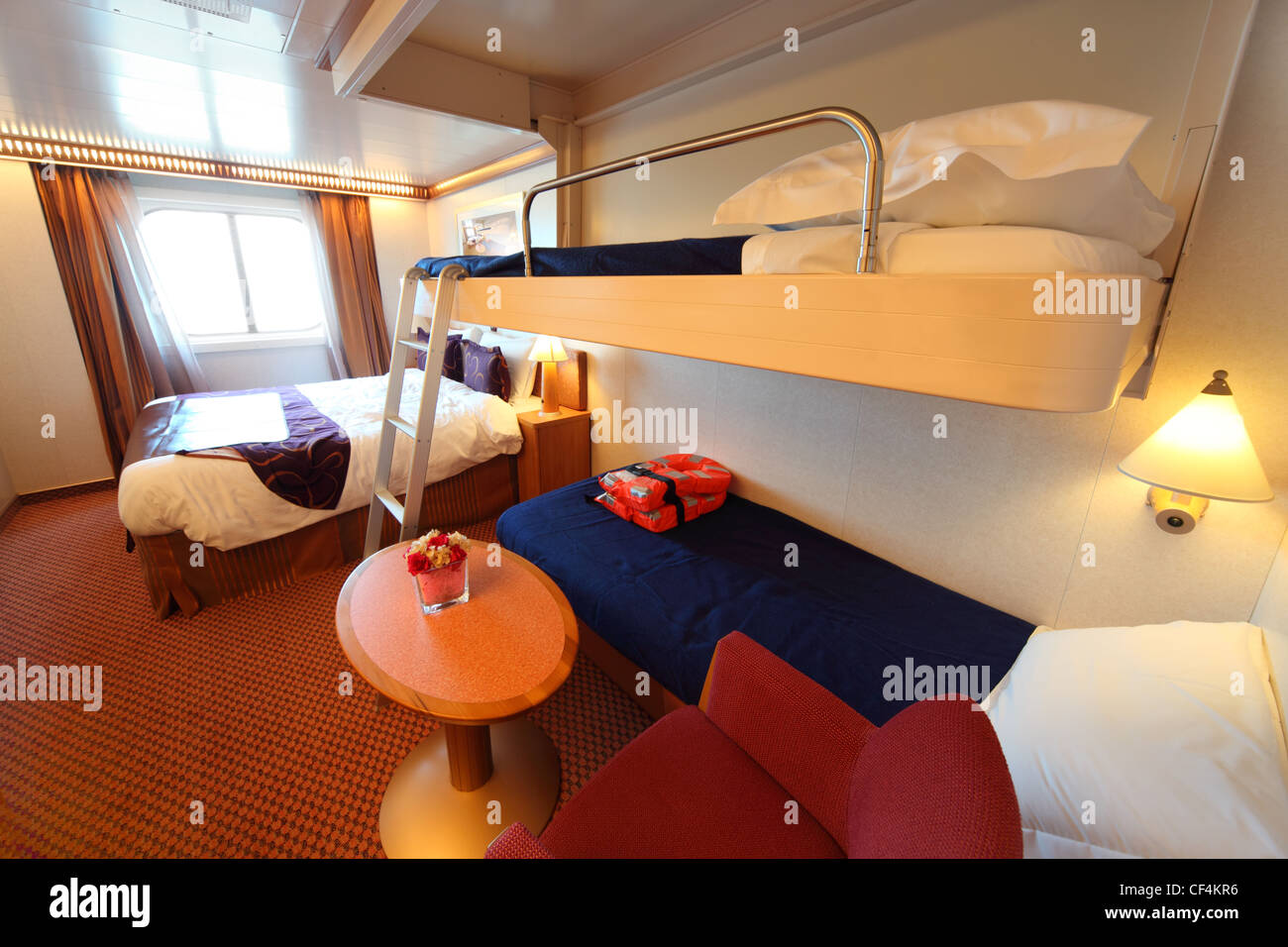 ship cabin with window, big double bed and two children beds general