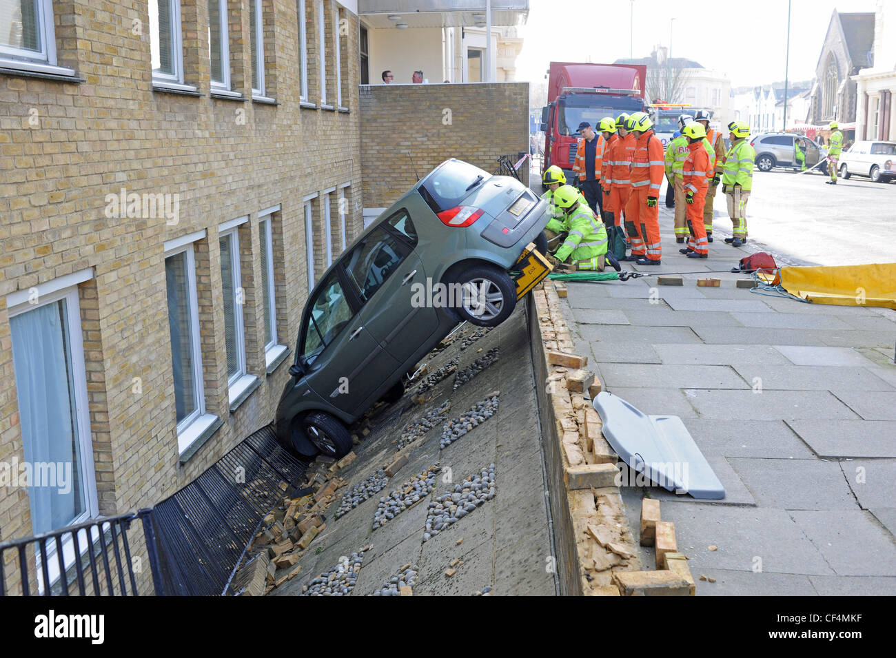 Emergency services attend to a Renault car which had crashed through