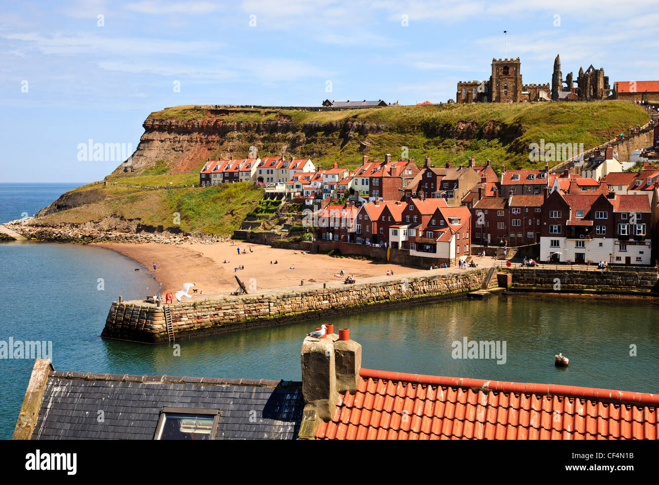 View over Whitby Harbour on a sunny day towards the Abbey on the hill top over looking the town. Stock Photo