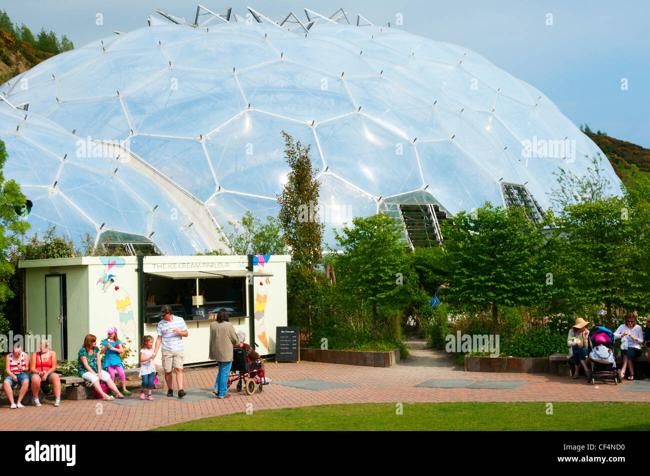 A refreshment hut at the Eden Project in front of one of the plant biomes. Stock Photo