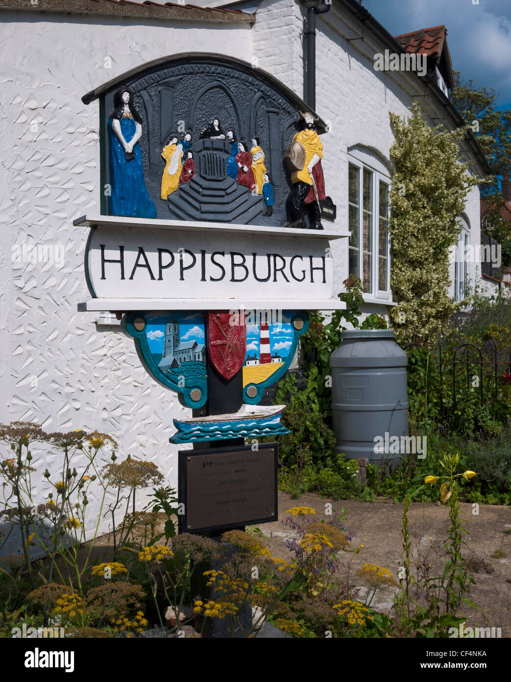 The Happisburgh village sign, depicting figures and landmarks from the villages past. Stock Photo