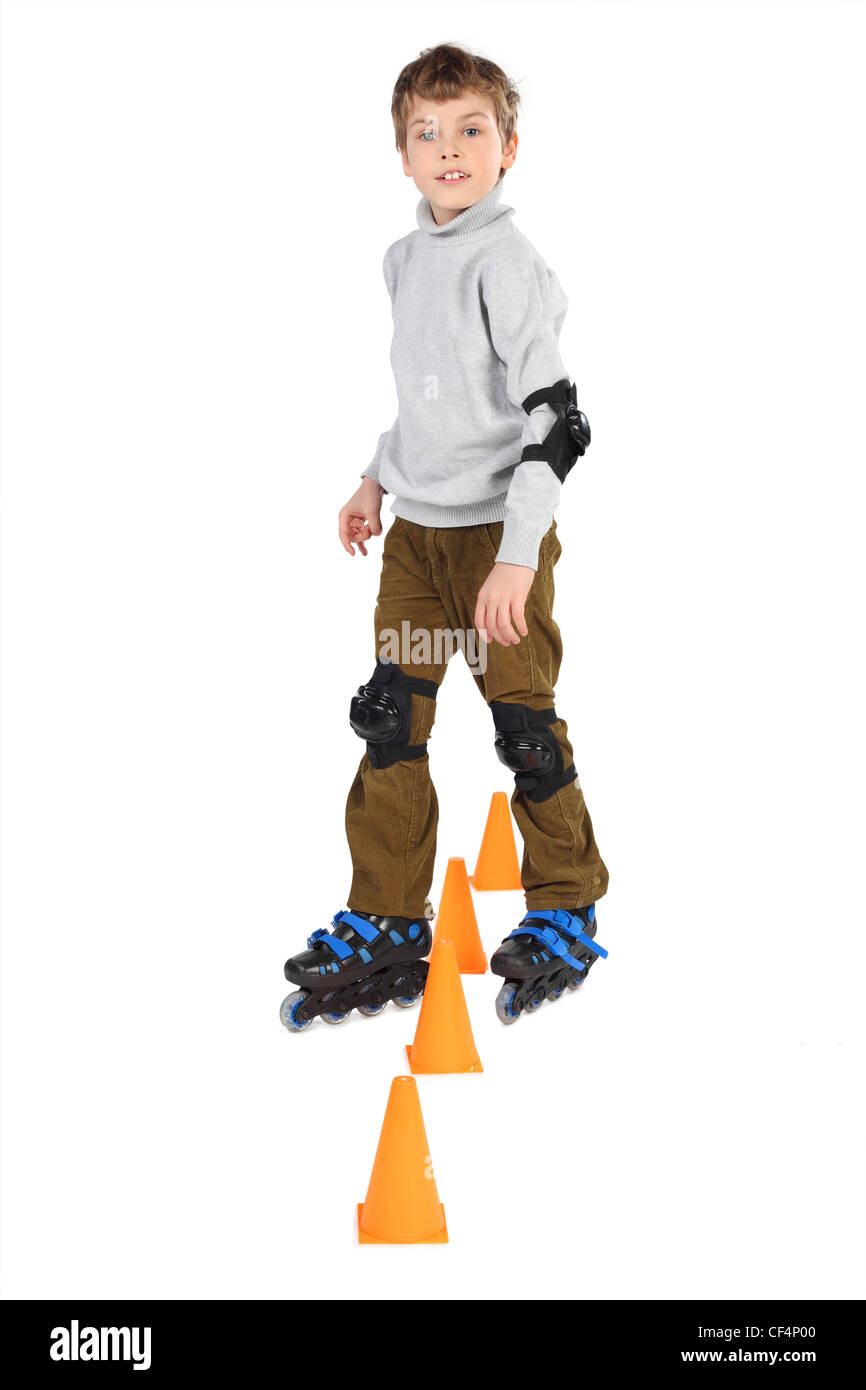 little roller boy clears obstacles orange cones looking at camera isolated on white Stock Photo