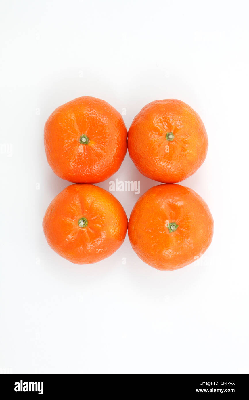 Four tangerines shot from above on white background. Stock Photo