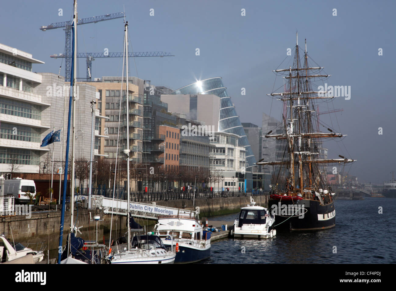 Boats and a tall ship at Dublin City Moorings on the River Liffey in the North Wall area. Stock Photo