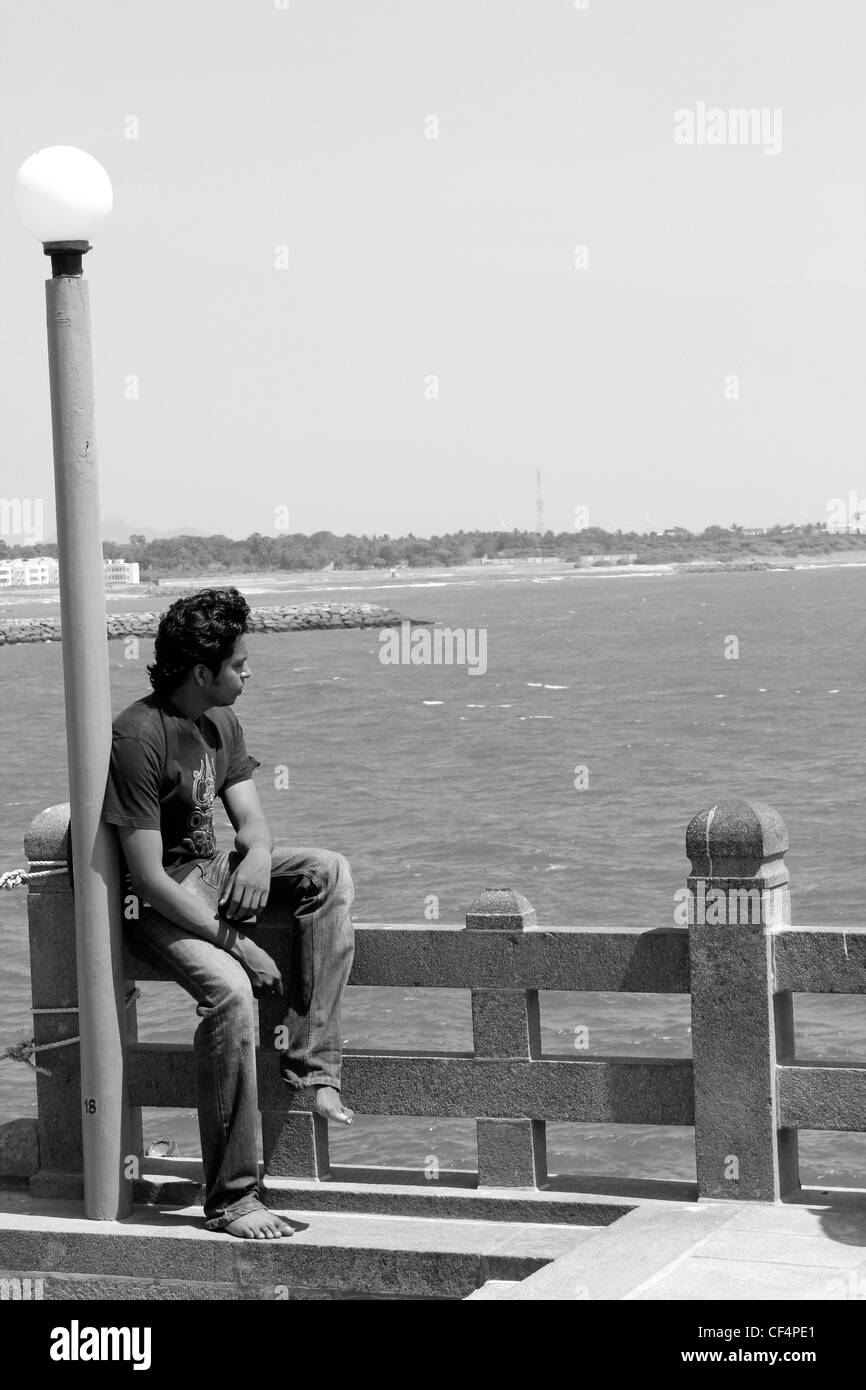 Young indian man thinking, looking afar Stock Photo