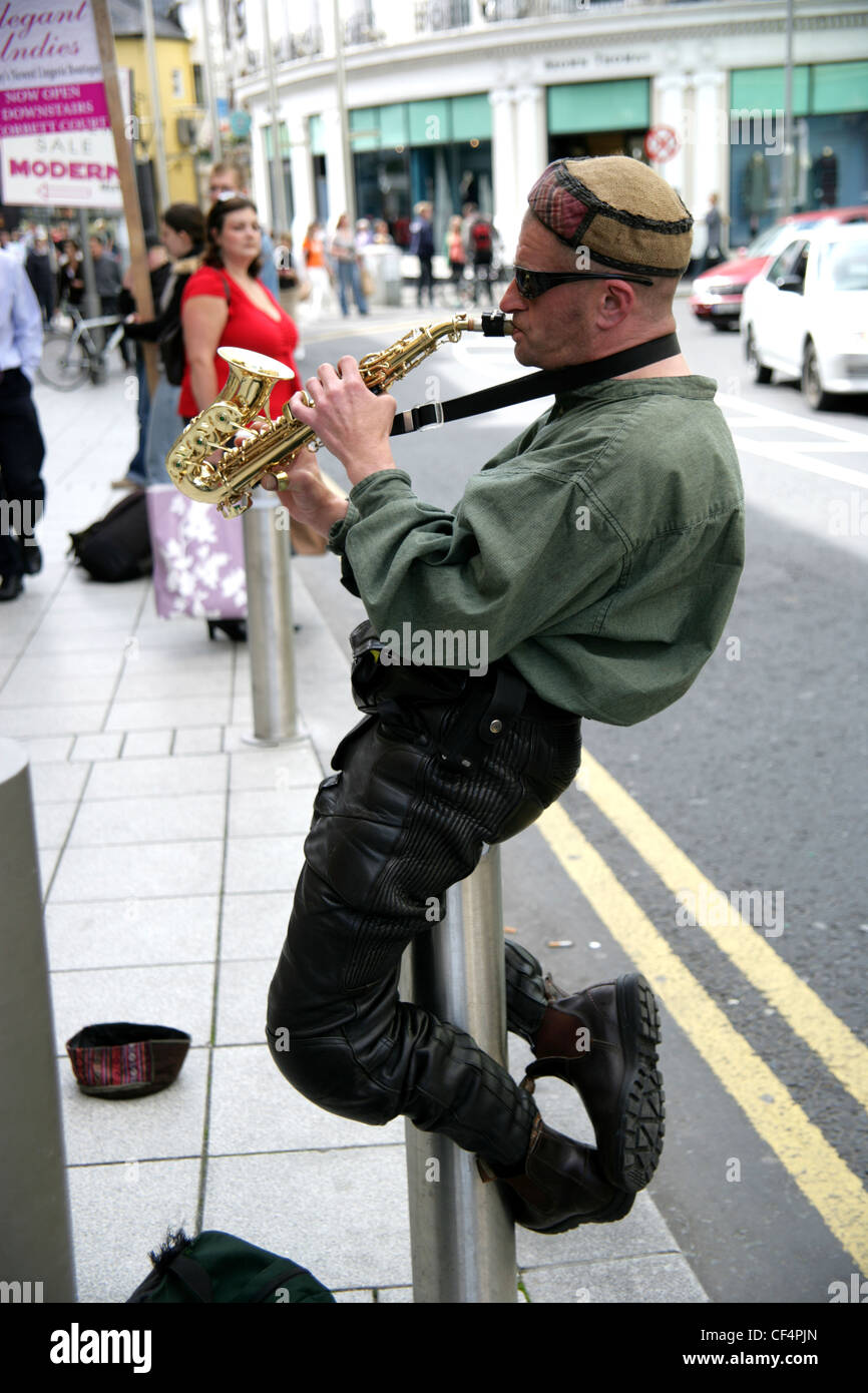 A busker performing with his saxaphone in Galway City. Stock Photo