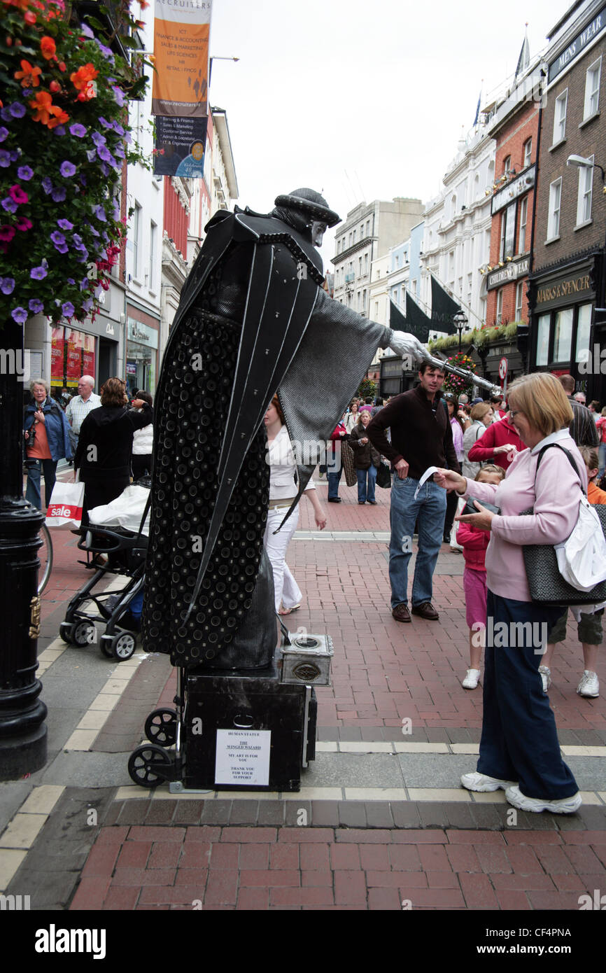 A street performer acting as a human statue, The Winged Wizard, in Grafton Street, Dublin. Stock Photo