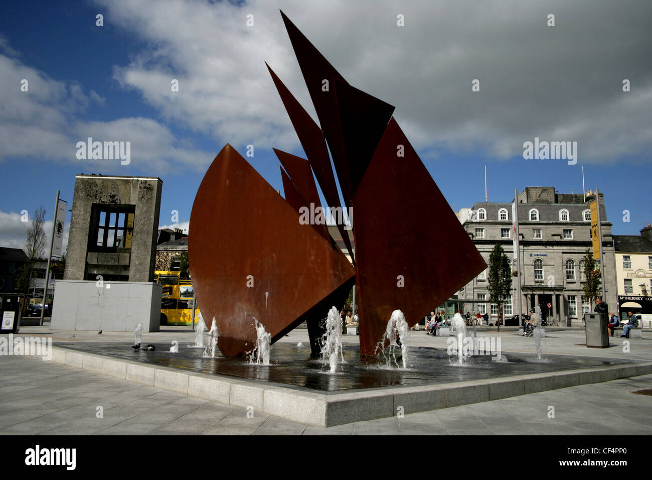 The Fountain in Eyre Square; built in 1984, consists of a copper-coloured representation of the sails of the Galway Hooker. This Stock Photo
