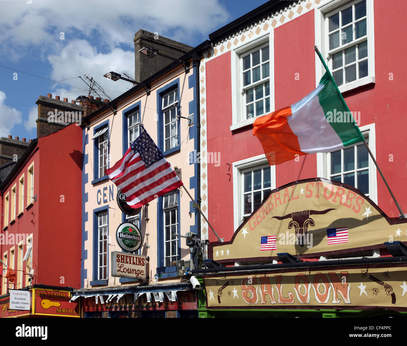 US and Irish flags flying ouside a General Stores in Main Street, Carrickmacross. Stock Photo