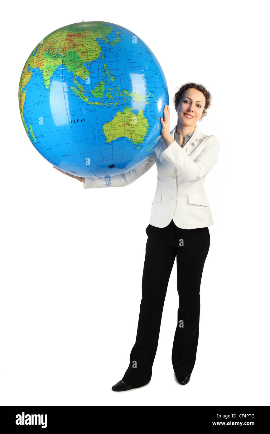 young woman in white jacket standing and holding for two hands big inflatable globe, isolated on white Stock Photo