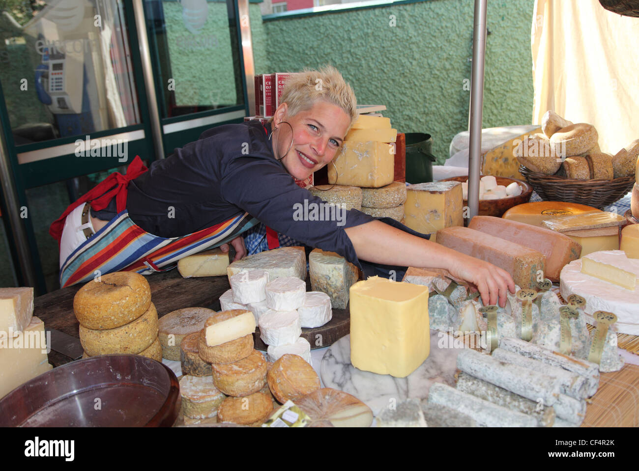 Artisan Cheesemaker Maja Binder with her handmade organic cheeses on her stall at Dingle Market. Stock Photo