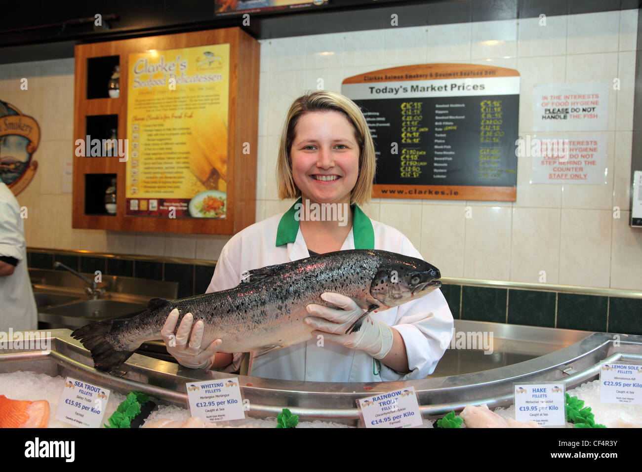 A wild Salmon held by a shop assistant in Clarke's Seafood Delicatessen. Clarke's has supplied salmon to the Vatican. Stock Photo