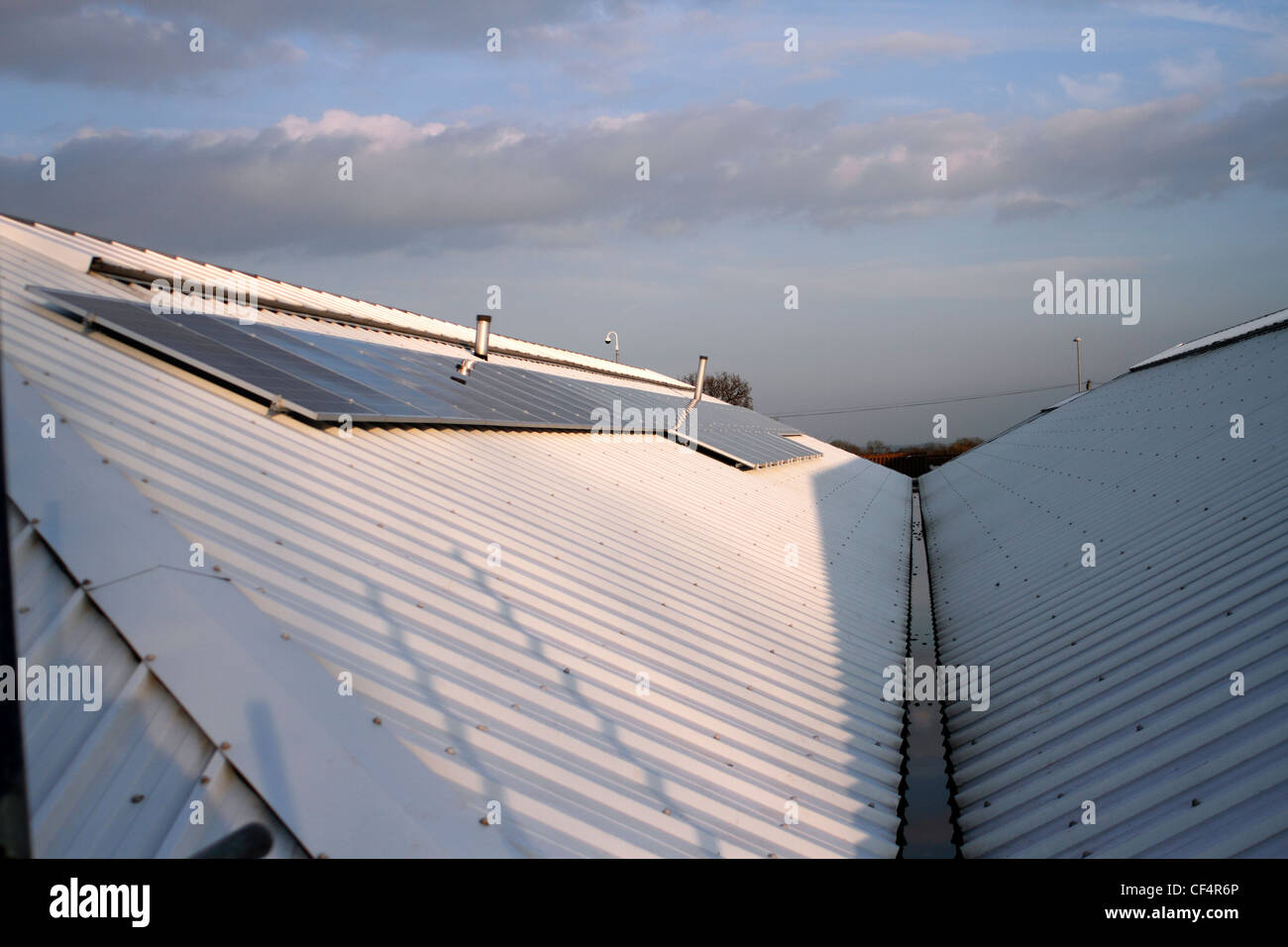 40 solar panels on a garden Centre roof - providing 10 kilowatts of energy Stock Photo