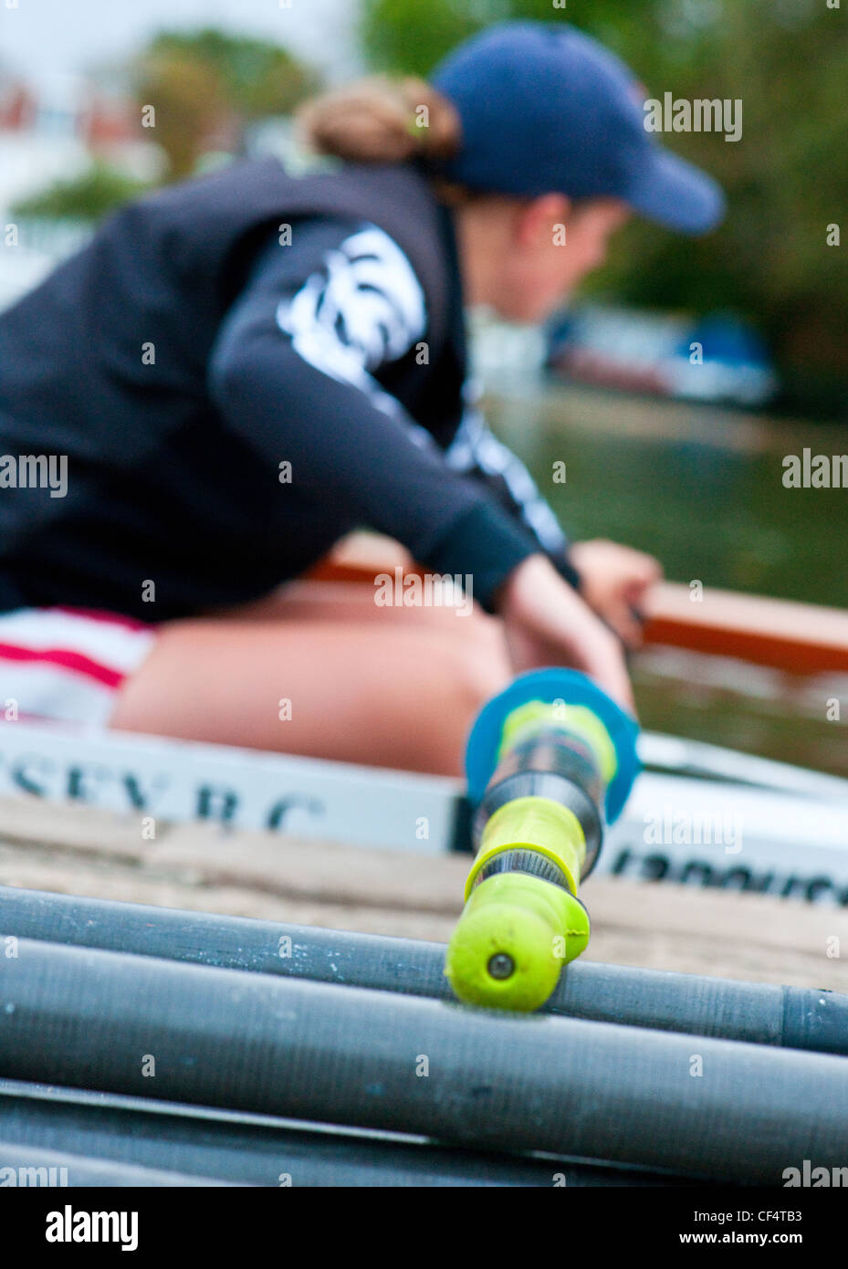 Close-up of a woman rowing at Molesey Boat Club on the River Thames. Stock Photo