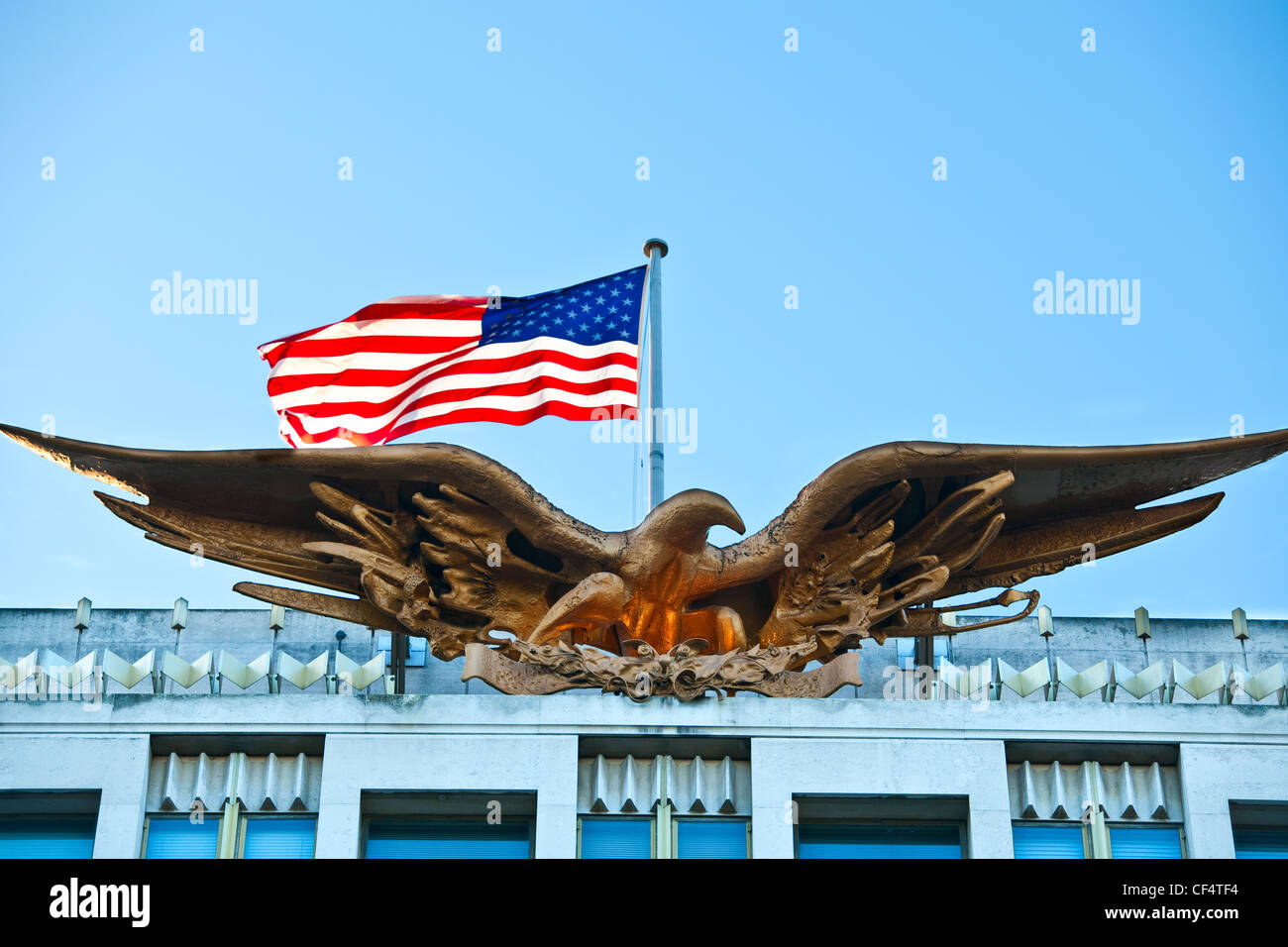 The Bald Eagle and stars and stripes flag on top of the US embassy. Stock Photo