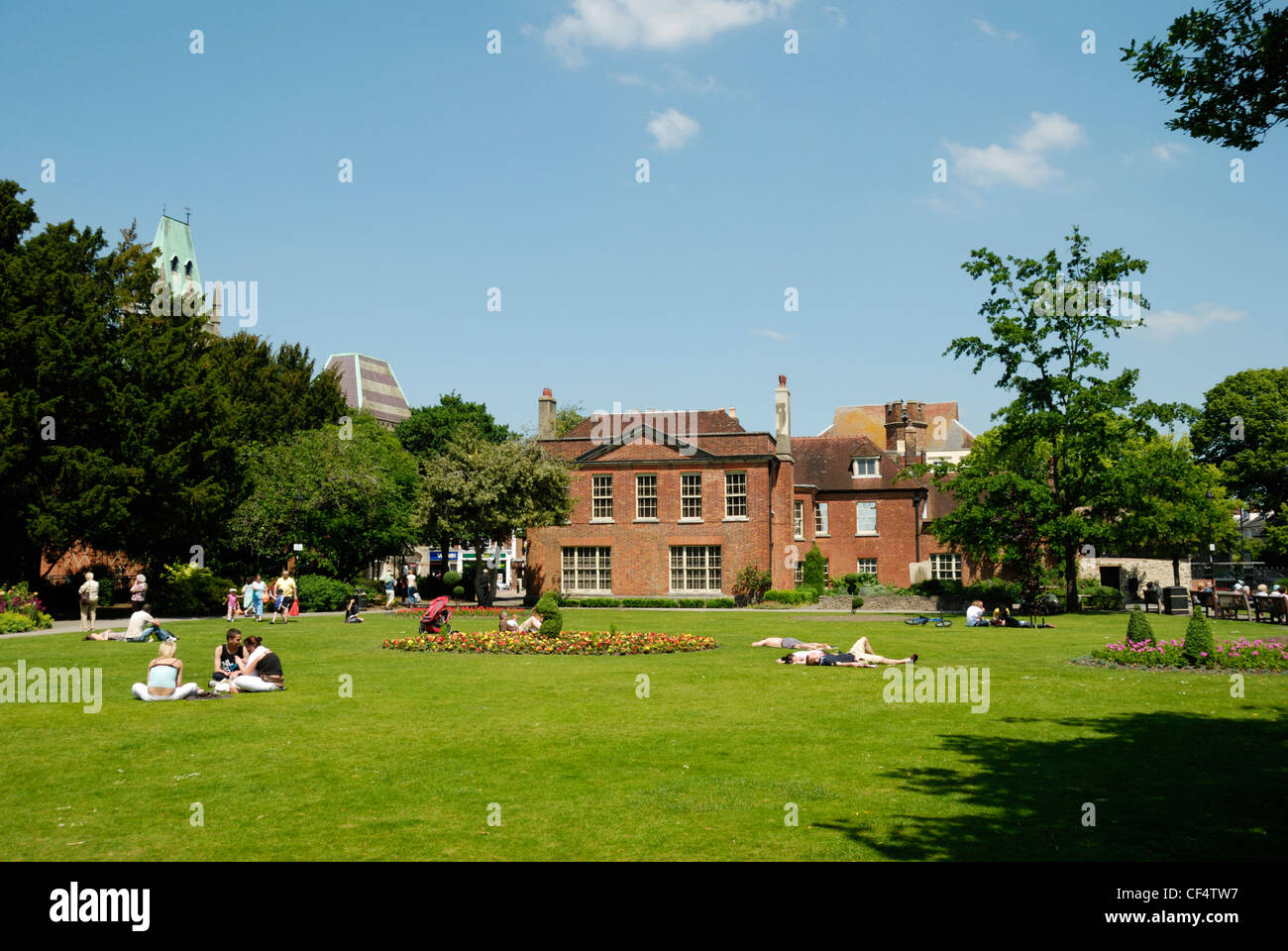 People relaxing in Abbey Gardens with Abbey House in the distance. Stock Photo