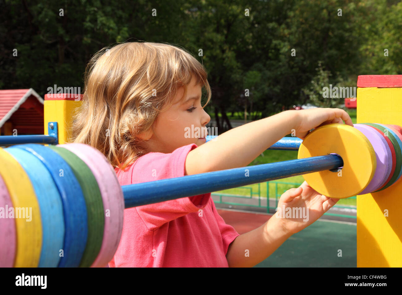 young girl playing at playground in summer sunny day, moves colour ...