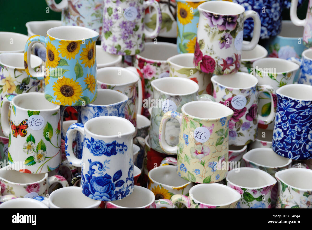 Colourful English China jugs displayed on a market stall in Portobello Road. Stock Photo