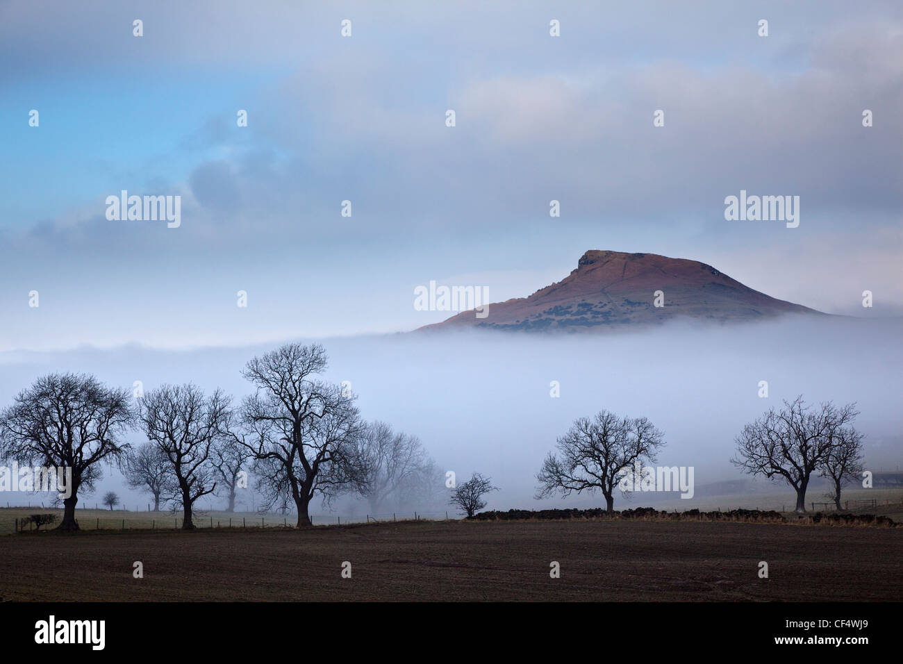 February mist revealing the distinctive summit of Roseberry Topping often compared to the Matterhorn in Switzerland. Stock Photo