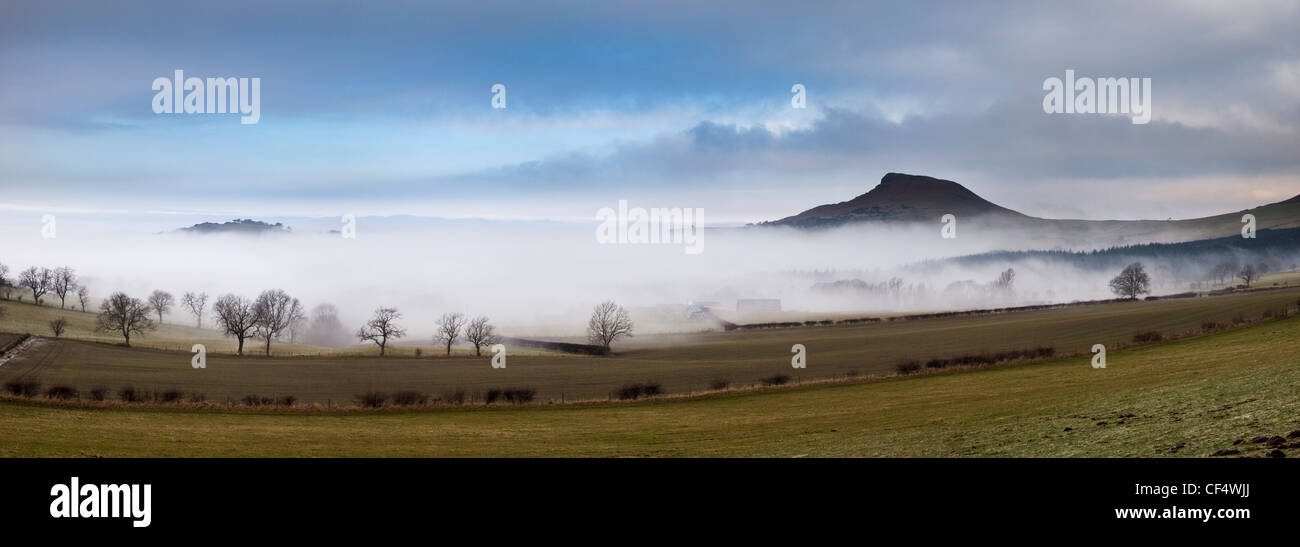 February mist revealing the distinctive summit of Roseberry Topping often compared to the Matterhorn in Switzerland. Stock Photo