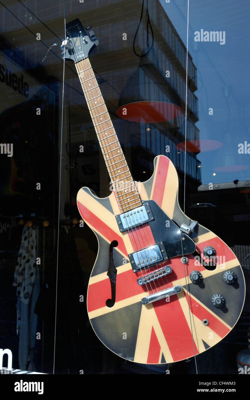 An electric guitar decorated with a Union Jack in a shop window. Stock Photo