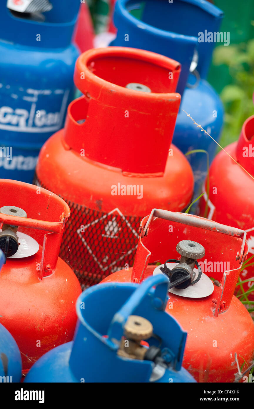 Red and blue propane and butane calor gas containers Stock Photo Alamy