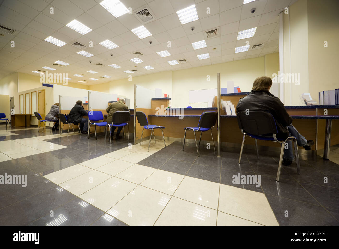 Bank office, Servicing branch, Cabins of operators, Clients of bank Stock Photo