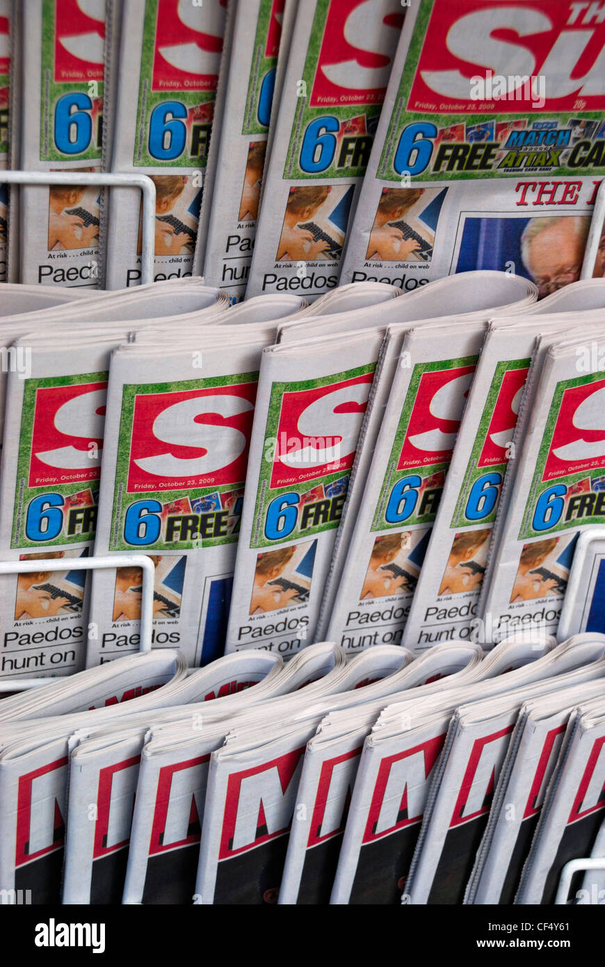 Red top tabloid newspapers for sale on a stand. Stock Photo