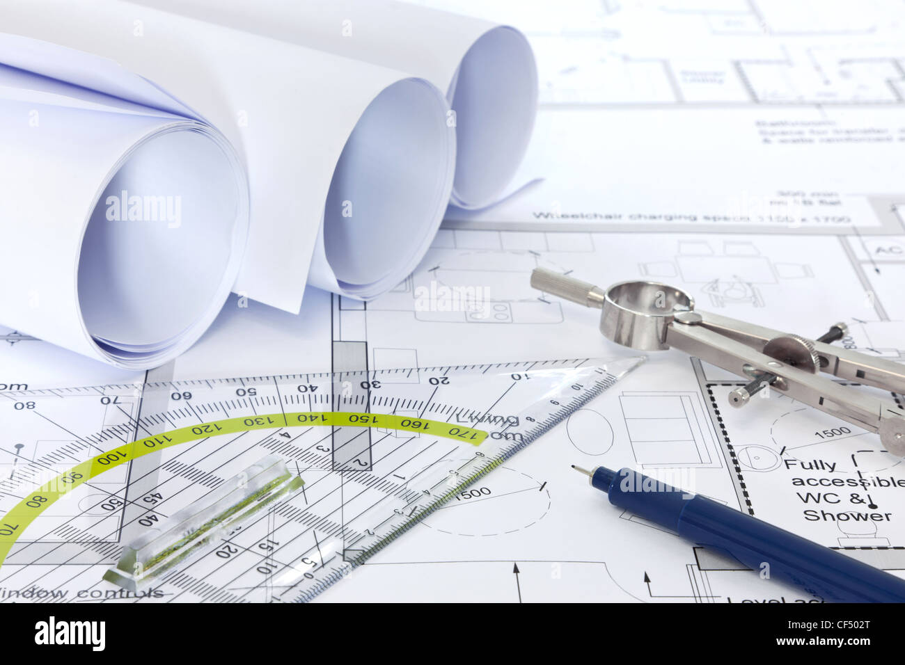 Still life photo of architectural floor plans with drawing instruments Stock Photo