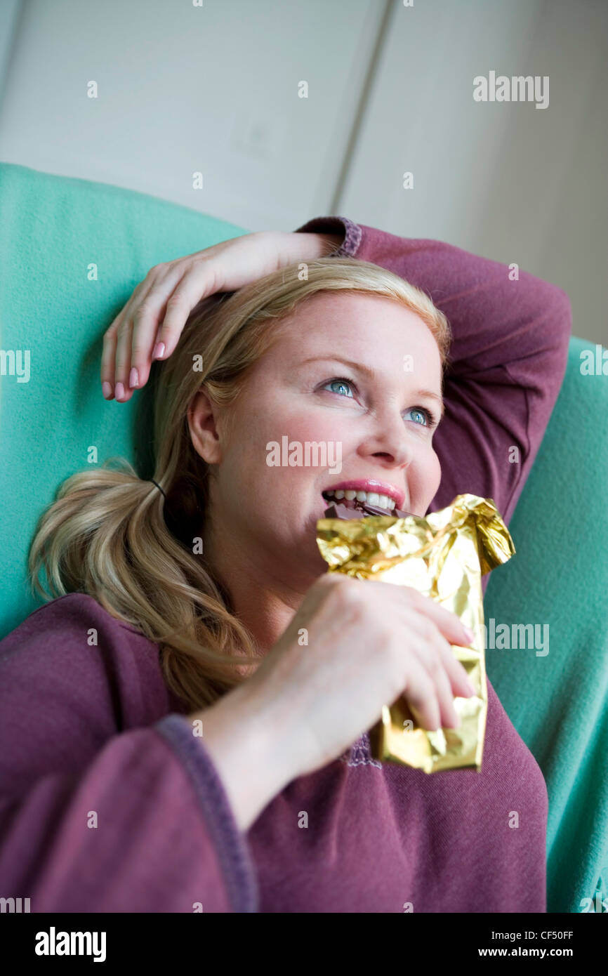 Close up of larger female blonde hair off face wearing purple top
