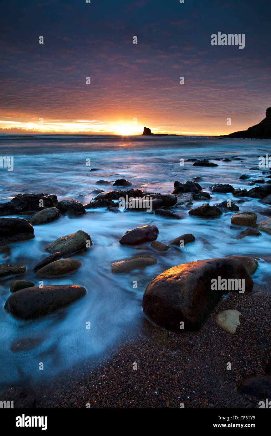 Dawn over Black Nab in Saltwick Bay near Whitby on the North Yorkshire Coast. Stock Photo