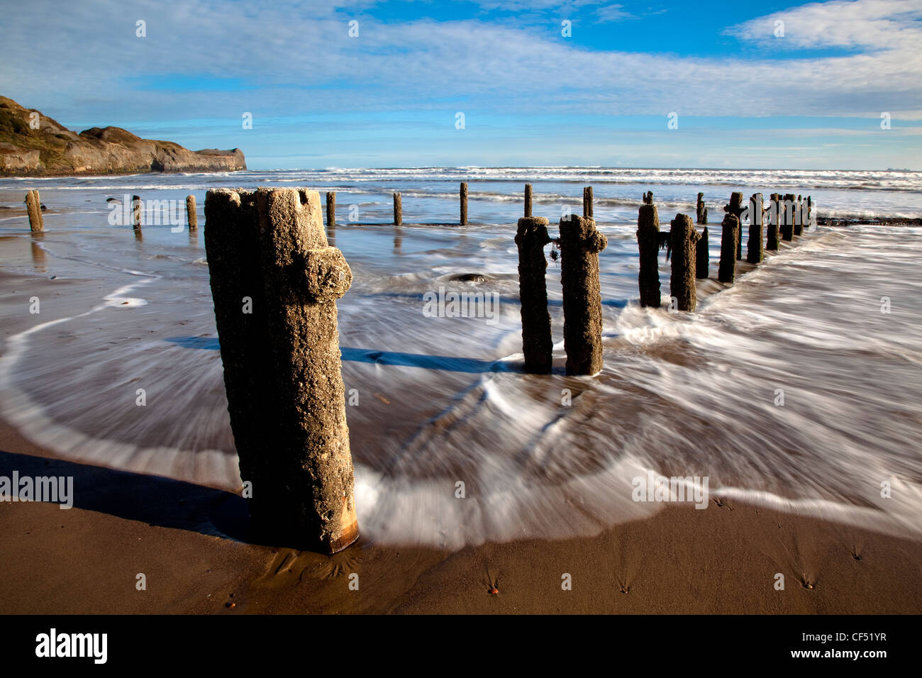 Waves from the North sea washing onto the shore around Groynes on Sandsend beach near Whitby on the North Yorkshire Coast. Stock Photo