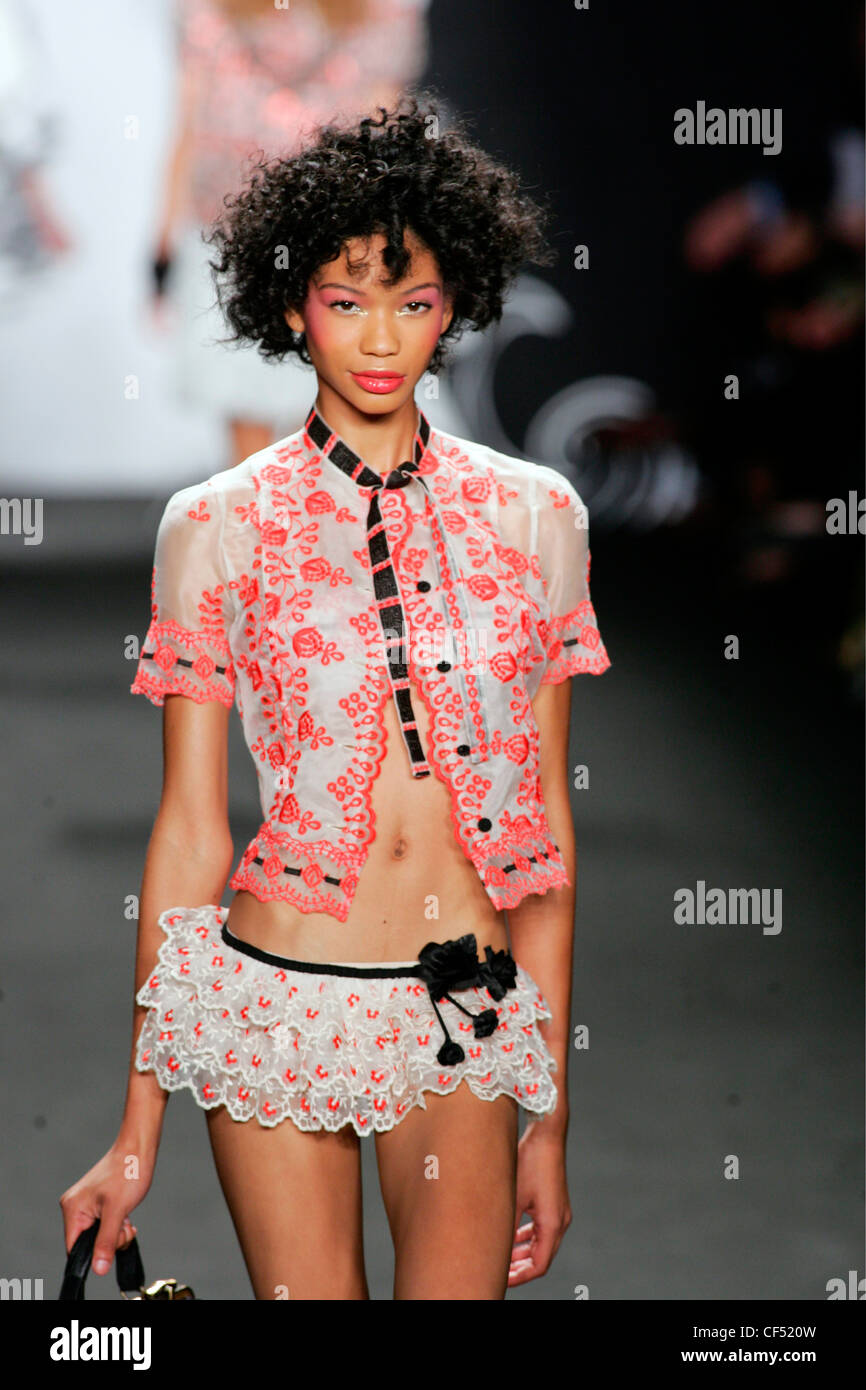 Anna Sui New York Ready to Wear Spring Summer Model Chanel Iman wearing a  cream and pink embroidered oriental style short Stock Photo - Alamy