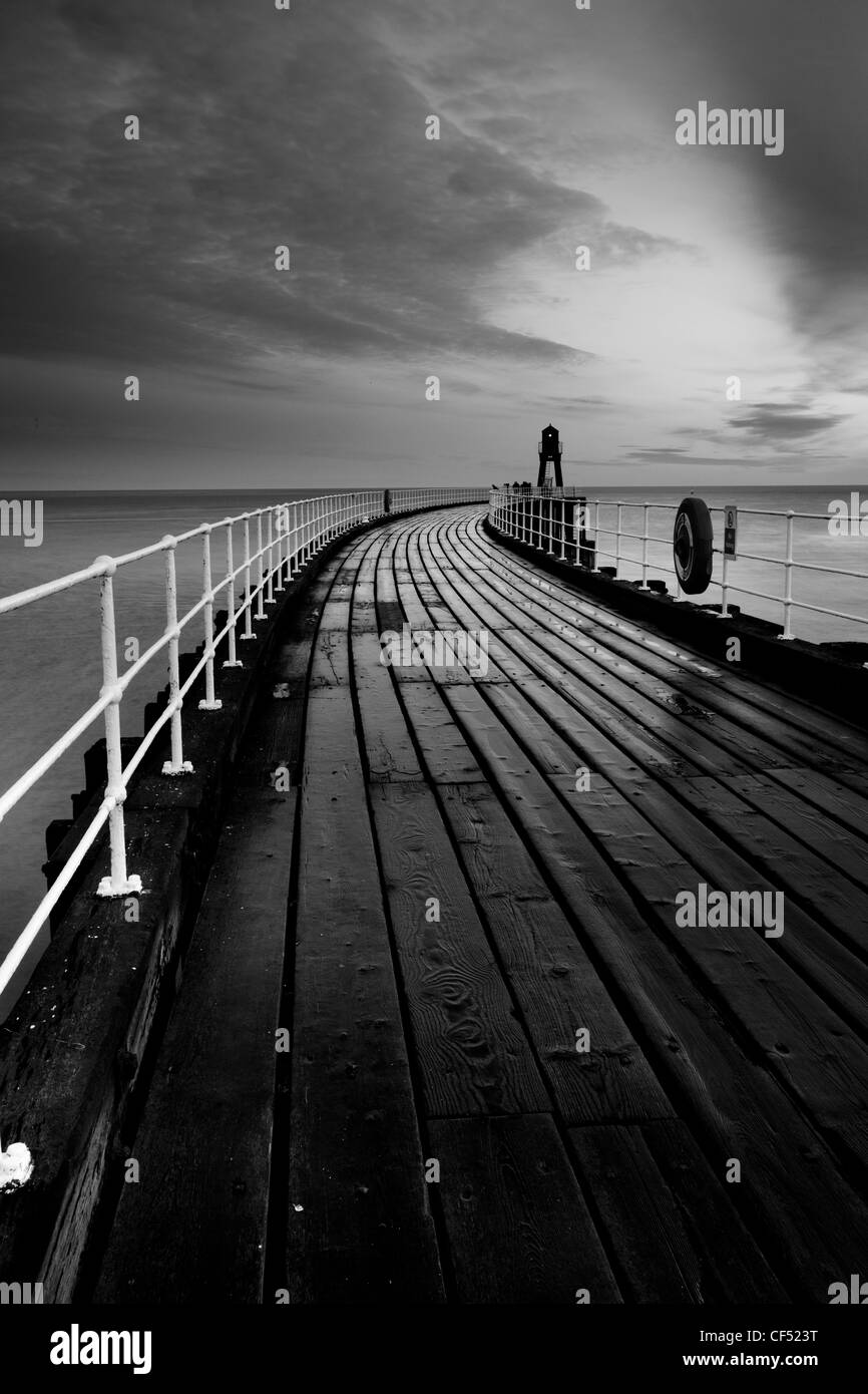 Whitby West Pier Light at the end of the West Pier at dawn. Stock Photo