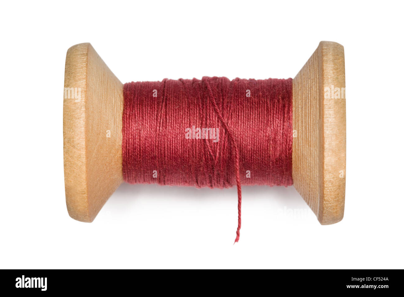 wooden coil with red threads isolated on white background Stock Photo