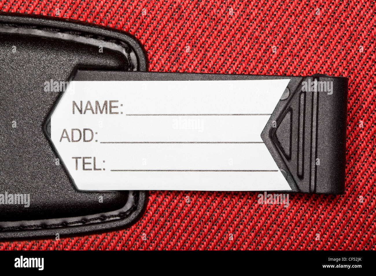 Label with identification data on red textural fabric Stock Photo