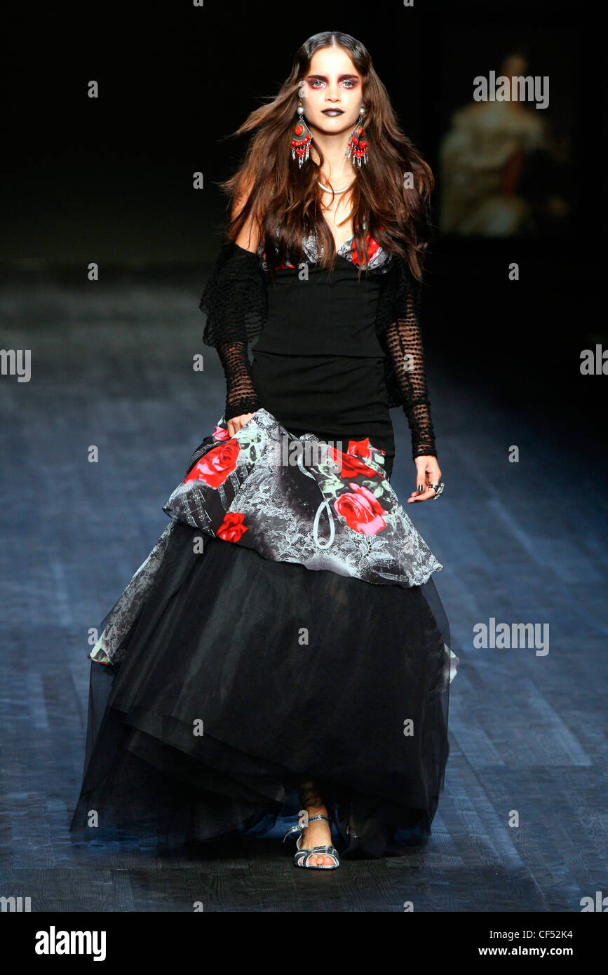 Mariella Burani Milan Ready to Wear Spring Summer Model dark makeup wearing  skirt and blouse tulle gothic black ball gown red Stock Photo - Alamy