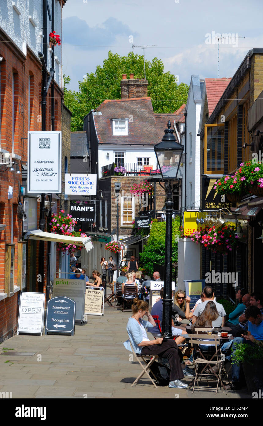 People relaxing outside cafes in Perrins Court, Hampstead. Stock Photo