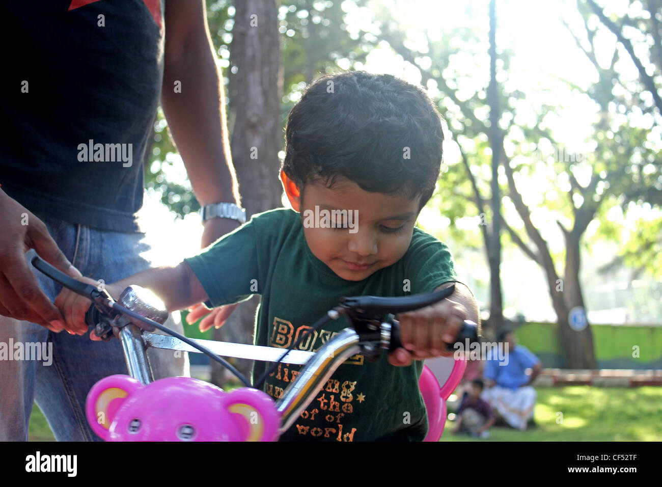 3 year old asian boy cycling Stock Photo