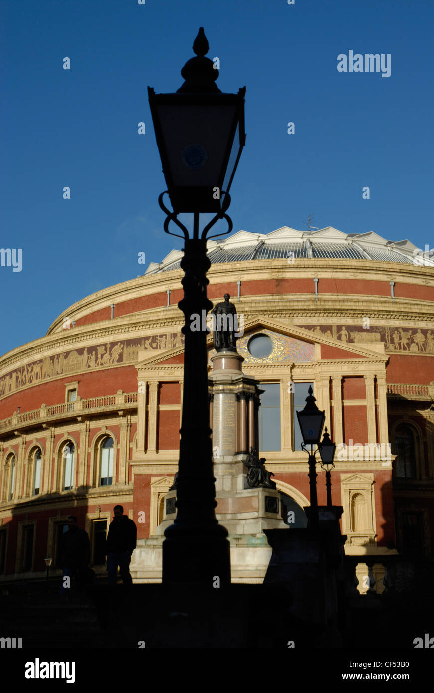 Victorian streetlamps silhouetted against the Royal Albert Hall in London. Stock Photo